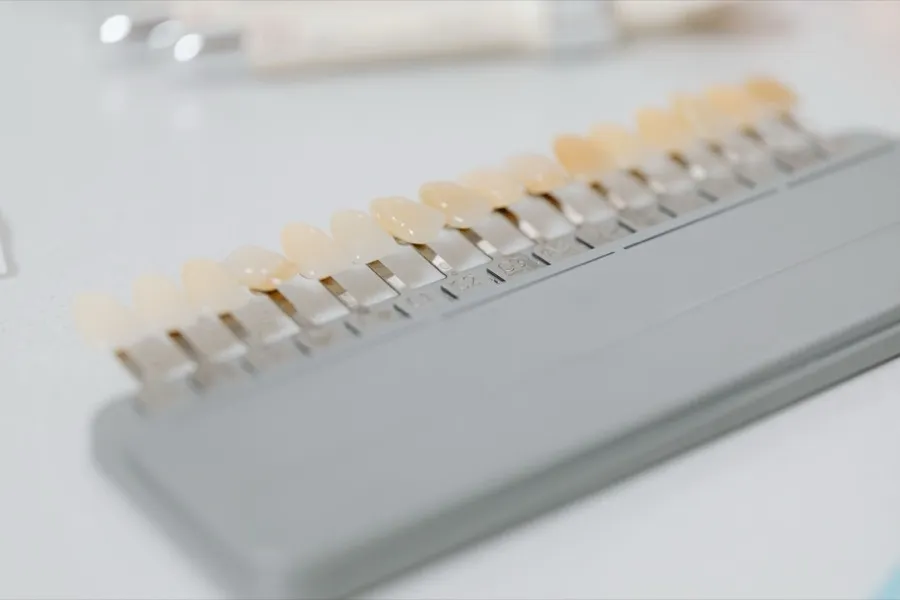 A dental shade guide showing a graded range of tooth colours