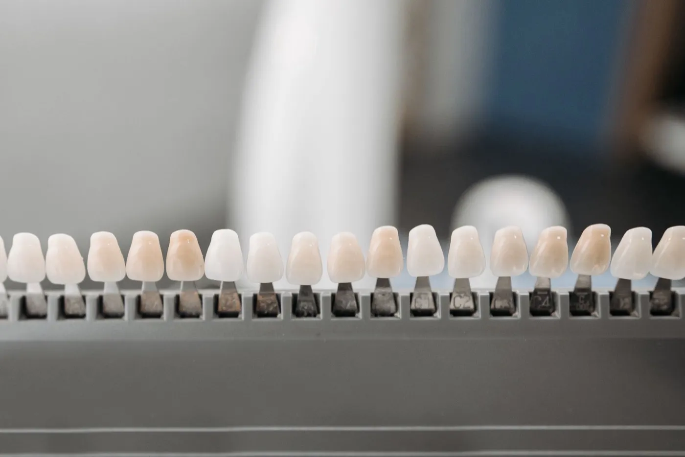 A rack of porcelain veneer samples in a range of tooth shades